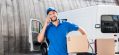 delivery-man-with-cardboard-box-talking-by-phone.jpg